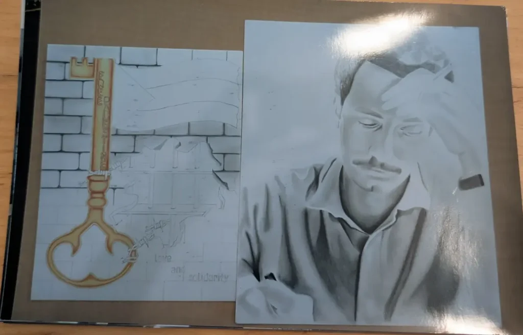 A photo of two pieces done by Lawrence Jenkins. The first piece features a old-fashioned golden key carved with the words 